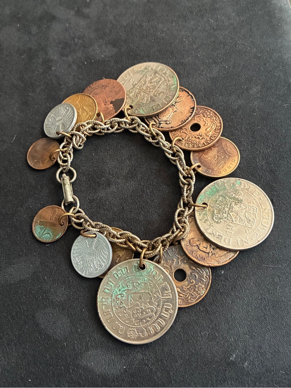 Vintage charm coin bracelet with pretty interesting coins dangling from the it